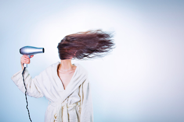 a woman blowing her hair